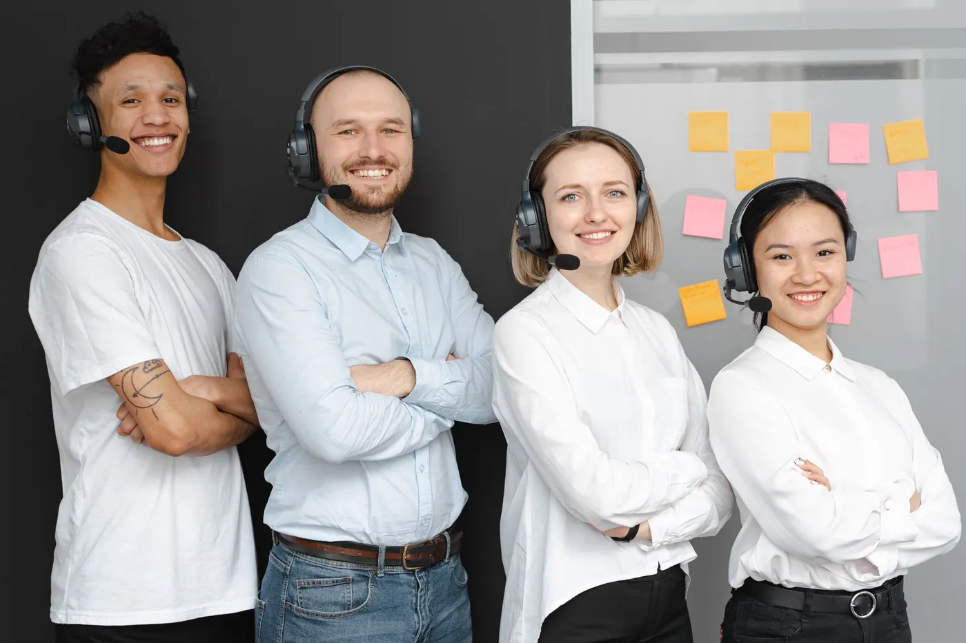 A smiling team of call centre agents wearing headsets